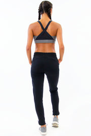 Back of Rare Active modern tearaway pants for women in black. 