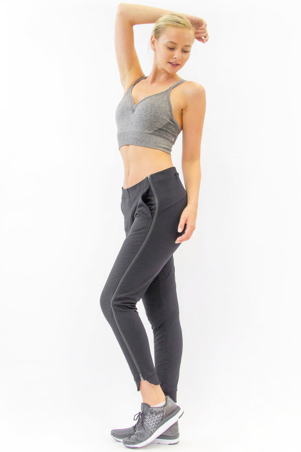 Side view of Rare Active modern tearaway pants for women in charcoal grey. 