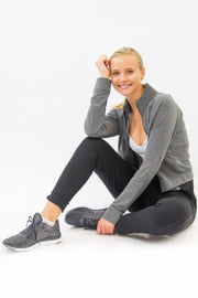 Model wearing Rare Active modern tearaway pants for women in charcoal grey. 